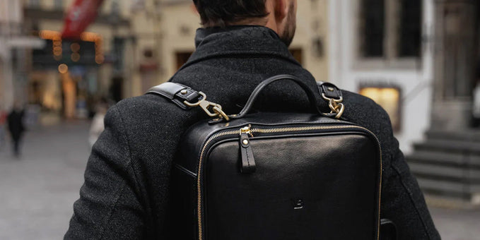 man wearing black leather backpack