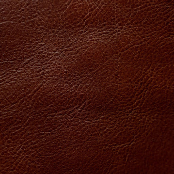 Close-up of a fine-grain textured Cuoio Superiore full-grain leather, naturally structured and vegetable-tanned, highlighting the quality and organic patterns.