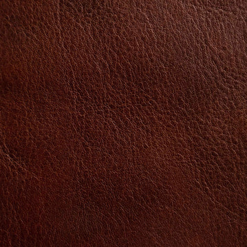 Close-up of a medium-grain textured Cuoio Superiore full-grain leather, naturally structured and vegetable-tanned, highlighting the quality and organic patterns.