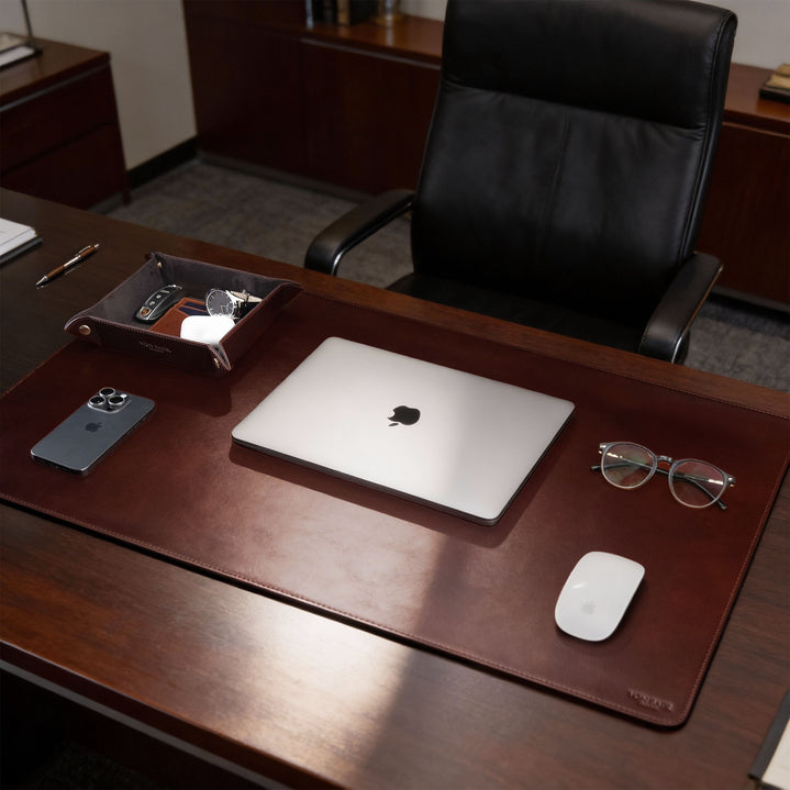 Von Baer Executive luxury full-grain leather desk pad in brown on a CEO office table with MacBook, professional desk accessory.