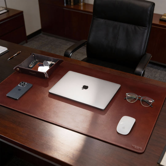 Von Baer Executive luxury full-grain leather desk pad in brown on a CEO office table with MacBook, professional desk accessory.