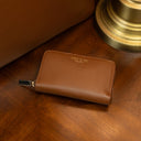 Compact RFID leather purse with coin pocket on a vintage table near an old lamp and a luxury tote bag