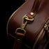 Von Baer 10x women's high-quality leather laptop travel bag in brown, featuring brass hardware close-up.