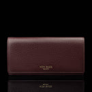 Von Baer Allure large burgundy full-grain leather accordion wallet with RFID protection and gold-tone branding, shown in a front view against a black background.