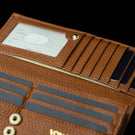 Von Baer Allure large cognac tan full-grain leather accordion wallet with RFID protection, shown in a close-up highlighting its hidden pocket and card slots against a black background.