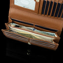 Von Baer Allure large cognac tan full-grain leather accordion wallet with RFID protection, shown open with dollar notes in its double compartment against a black background.
