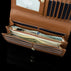 Von Baer Allure large cognac tan full-grain leather accordion wallet with RFID protection, shown open with dollar notes in its double compartment against a black background.