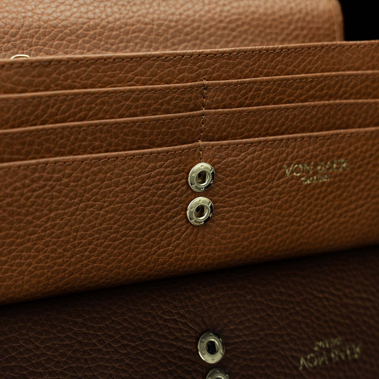 Von Baer Allure large cognac tan full-grain leather accordion wallet with RFID protection, shown in a close-up highlighting the snap button closure.