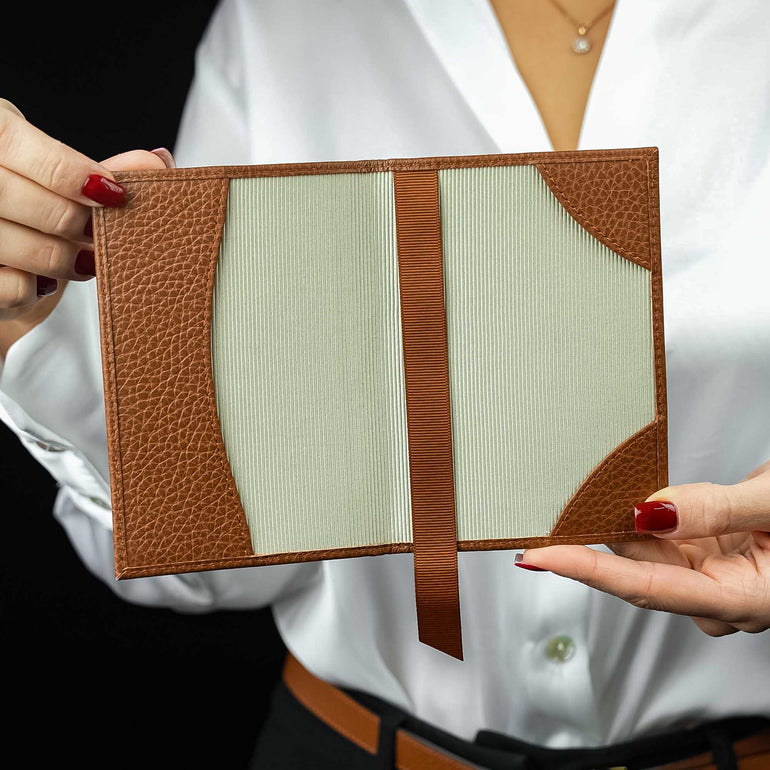 Von Baer Avia luxury leather passport holder open in a woman’s hands