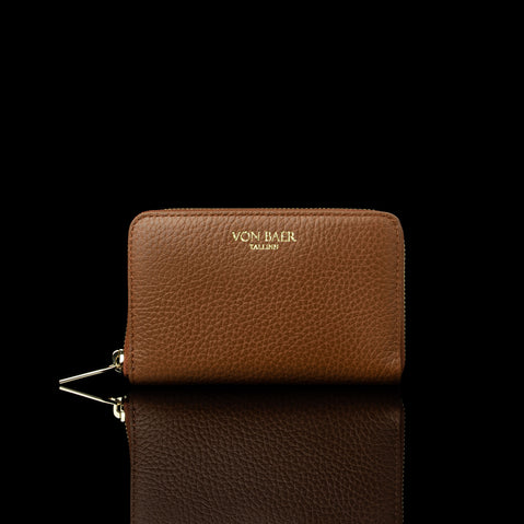 Von Baer Celeste small tan full-grain leather zip-around wallet with a gold-tone zipper, displayed in a front view against a black background.