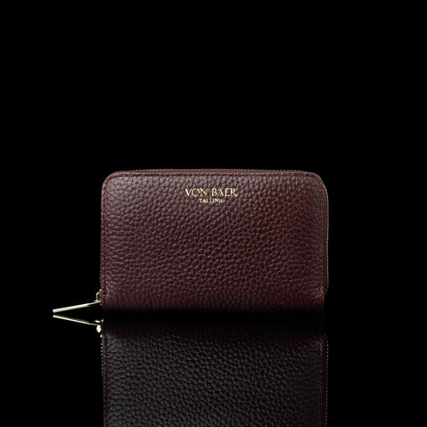 Von Baer Celeste small burgundy full-grain leather zip-around wallet with a gold-tone zipper, displayed in a front view against a black background.