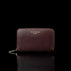 Von Baer Celeste small burgundy full-grain leather zip-around wallet with a gold-tone zipper, displayed in a front view against a black background.