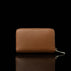 Von Baer Celeste small tan full-grain leather zip-around wallet shown in a back view, featuring RFID protection and premium leather texture against a black background.