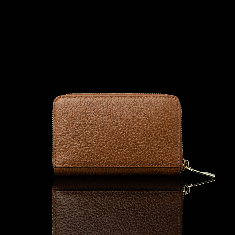 Von Baer Celeste small tan full-grain leather zip-around wallet shown in a back view, featuring RFID protection and premium leather texture against a black background.
