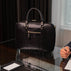 Von Baer City Business Leather Laptop Bag in black, on the table in the president suite.