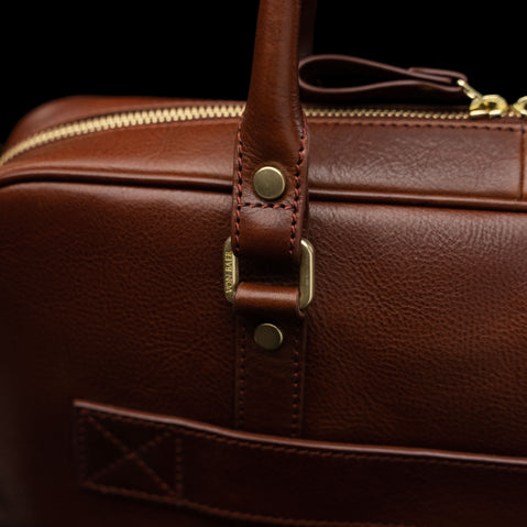 Von Baer City Business leather laptop bag in brown, featuring a logo on solid brass hardware, highlighting durability and sophistication.