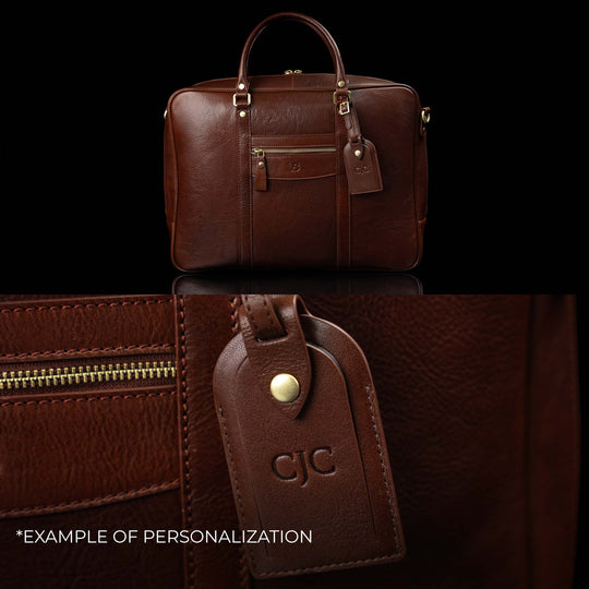 A Von Baer City leather laptop bag showing an example of personalization with embossed initials on the attached luggage tag.