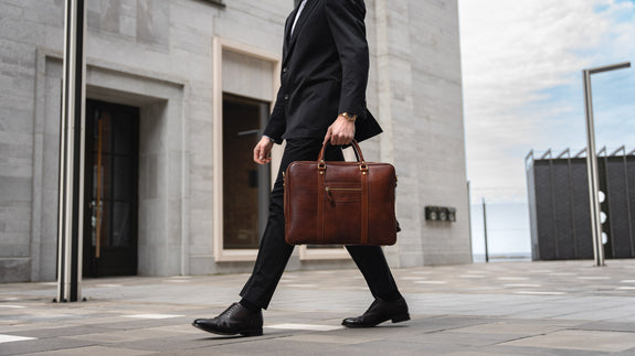 Von Baer City top luxurious large leather men's laptop bag for lawyers, carried by a male model, slider.