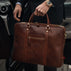 von baer city top luxurious large leather mens laptop bag for work brown carried by man in a suit near mercedes