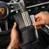 Von Baer Classic bifold leather wallet in black, stuffed with cash and credit cards like American Express, shown with a man taking out dollars in a Porsche interior