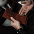 von baer classic bifold luxurious leather brown color wallet man putting coins inside