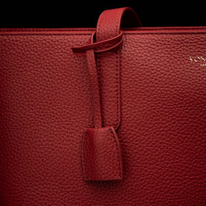 Von Baer decorative leather clip with snap hook in red color on tote bag, front view showing premium hardware detail.