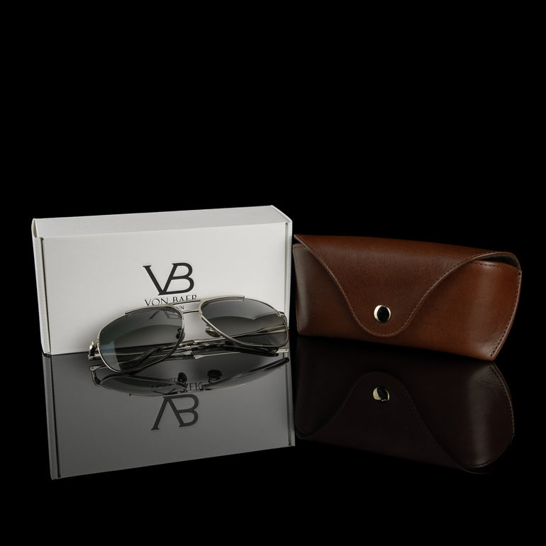A brown Von Baer Deluxe luxury leather glasses and sunglasses case with a gift box and glasses.