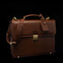 Compact full-grain leather laptop briefcase with shoulder strap and luggage tag for professional work, brown perspective view by Von Baer diplomat.