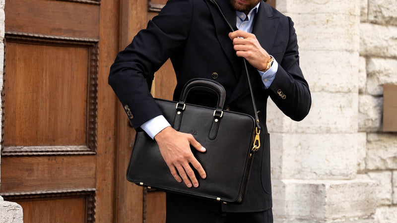An elegant Von Baer slim black leather laptop bag with a shoulder strap.