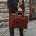 von baer essential modern professional italian leather briefcase for men solid brown male model holds in hand