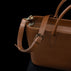 Von Baer Estelle brown leather crossbody tote bag for women, shown from the rear three-quarter view with adjustable shoulder strap, buckle and gold-tone hardware.