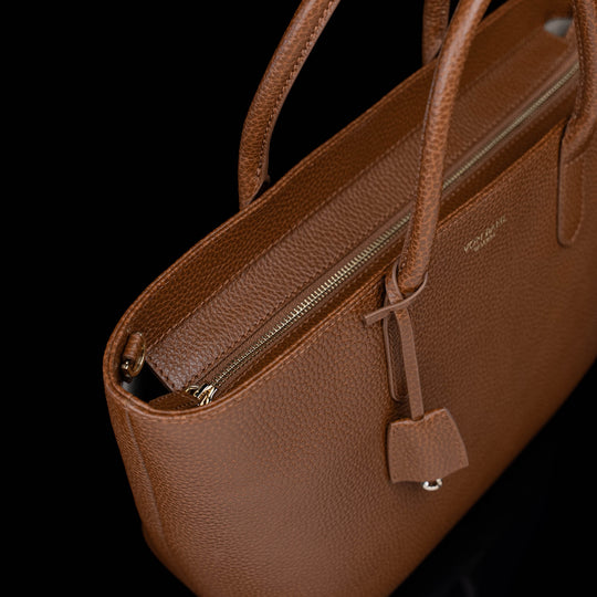 Von Baer Estelle brown leather tote bag for women with close-up view of the secure zip-top closure, pebbled leather texture and structured top handles.