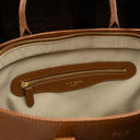 Von Baer Estelle brown small leather tote bag for women, showing the cream-lined interior with a leather-trimmed zipped pocket and gold-tone hardware.