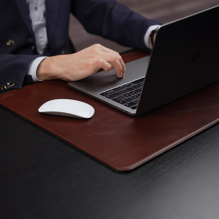 Von Baer Executive large brown leather desk pad and laptop mat used by businessman in suit working on MacBook