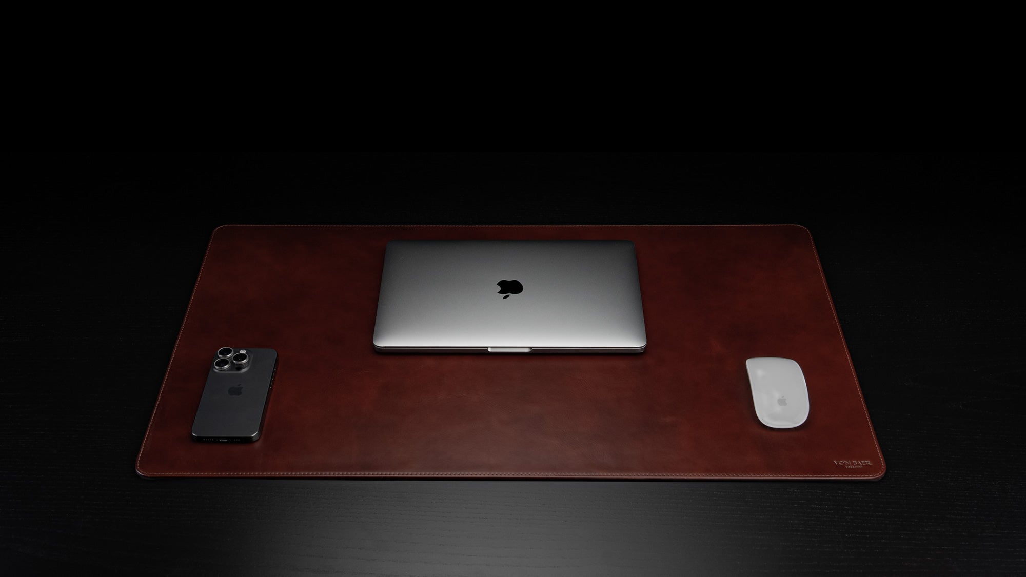 Von Baer Executive large luxury leather desk mat in high-quality brown, featuring a front view with a MacBook placed on top, perfect as a sophisticated and stylish gift idea.