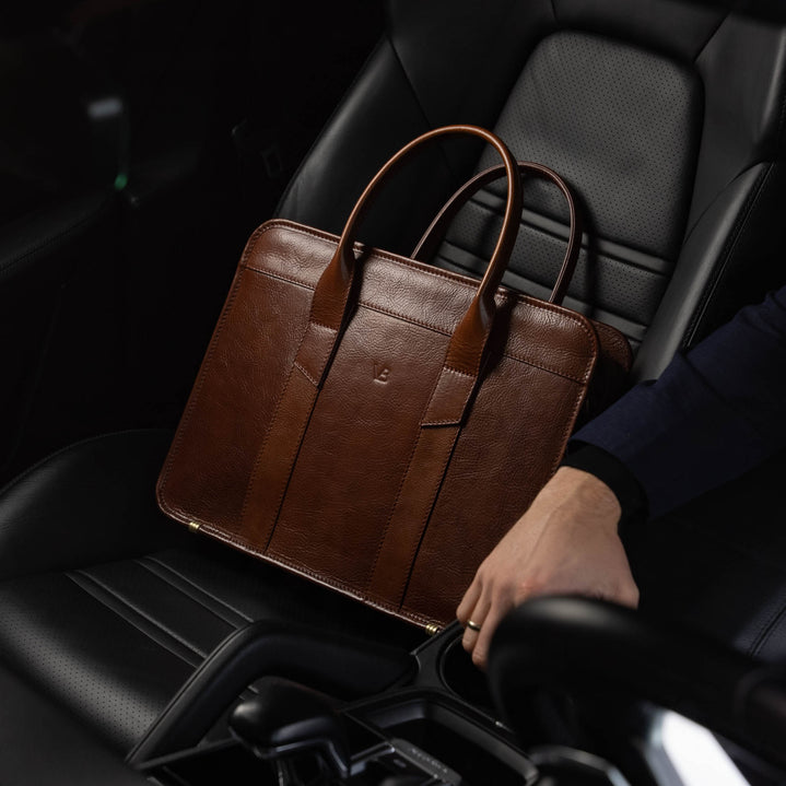 Men’s Von Baer Exquisite luxury slim full-grain leather laptop bag in the Porsche, near a male model.