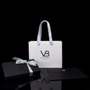 Von Baer luxury gift packaging displayed alongside Allure large leather accordion wallets, a travel organizer, and a leather luggage tag.
