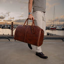 Von Baer Grand Large Full-Grain Leather Garment Travel Bag (Man Carrying, Sunset Yacht Marina)