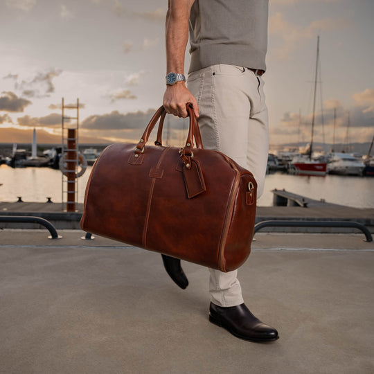 Von Baer Grand Large Full-Grain Leather Garment Travel Bag (Man Carrying, Sunset Yacht Marina)
