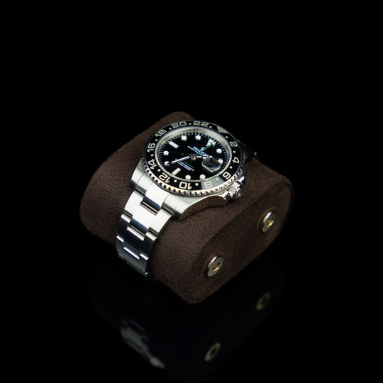 Upper view of a brown Von Baer Hamilton luxury leather watch roll, showing the detachable cushion with a Rolex watch.