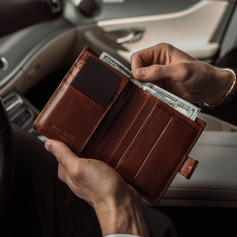 Von Baer heritage premium men's leather trifold wallet in solid brown, with cash in the car.
