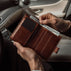Von Baer heritage premium men's leather trifold wallet in solid brown, with cash in the car.