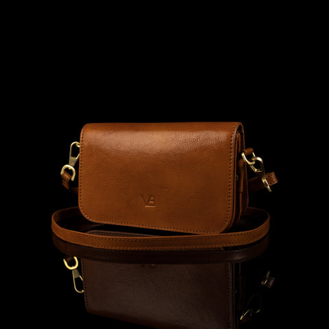 Von Baer Isabella luxury mini leather crossbody bag with adjustable strap in tan color.