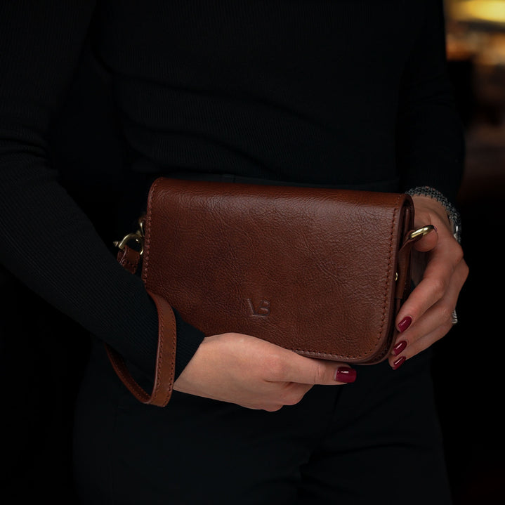 Von Baer Isabella luxury mini leather crossbody bag/wristlet in the hands of a female model.