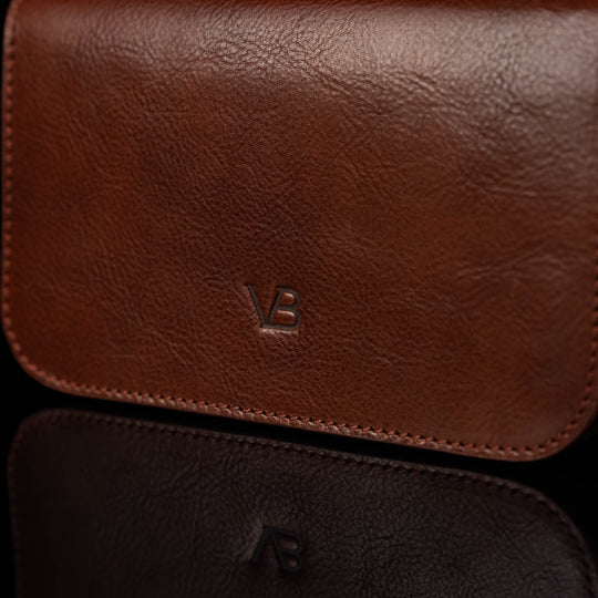 Von Baer Isabella luxury small full-grain leather shoulder bag with adjustable strap in brown, featuring the Von Baer logo.