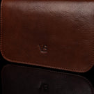 Von Baer Isabella luxury small full-grain leather shoulder bag with adjustable strap in brown, featuring the Von Baer logo.