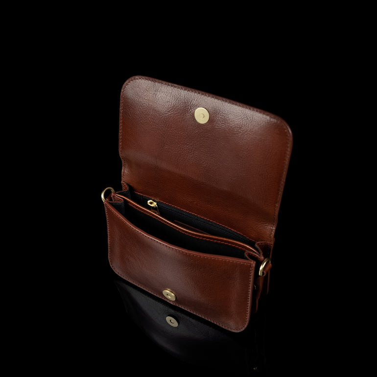 Von Baer Isabella small full-grain leather shoulder bag in brown, featuring two compartments and a zipped pocket inside.