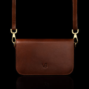 Von Baer Isabella small leather shoulder bag with adjustable strap in brown, front view.