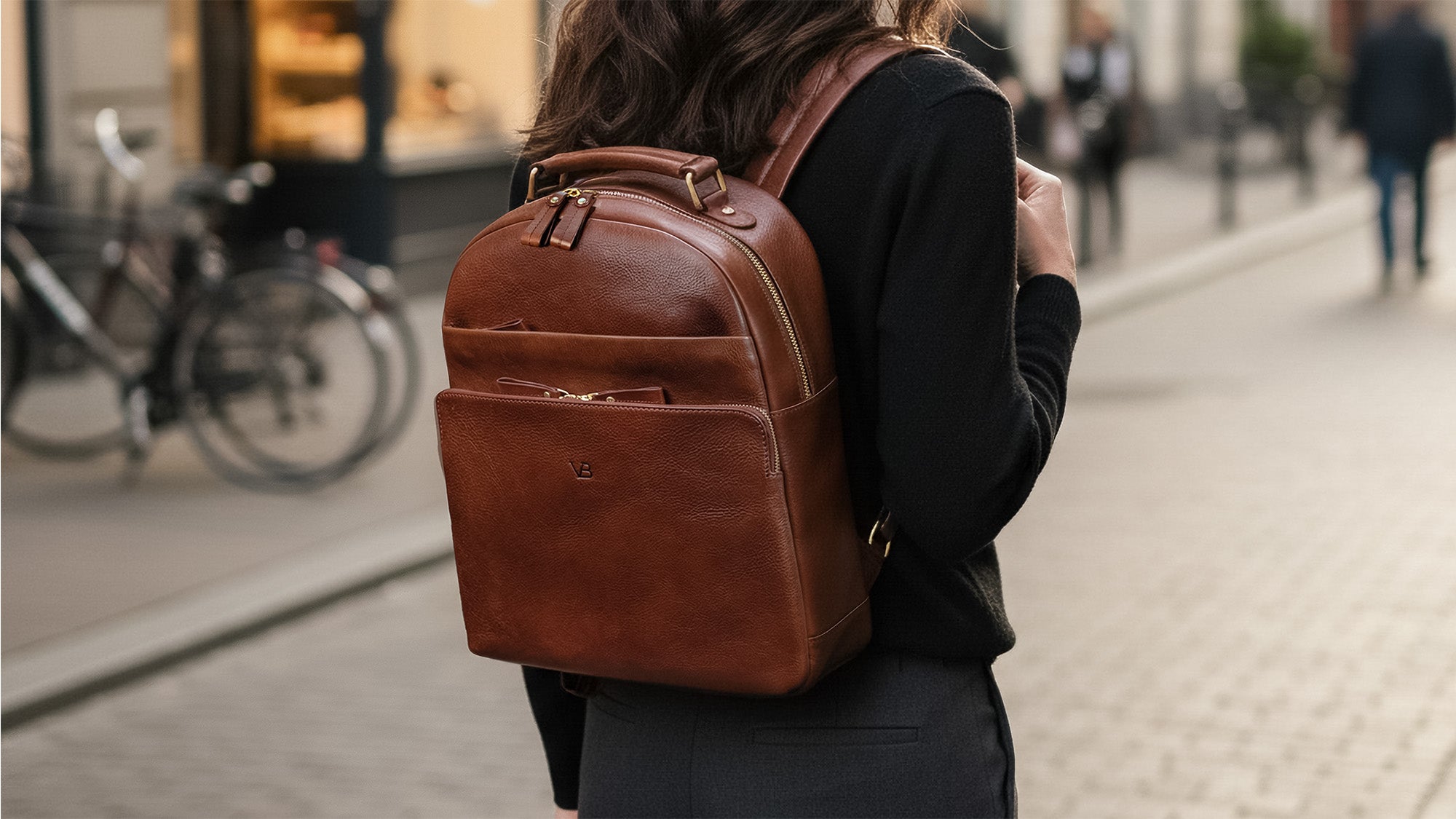 Von Baer Liberty full-grain leather backpack for women on a city street, stylish bag for work and travel.