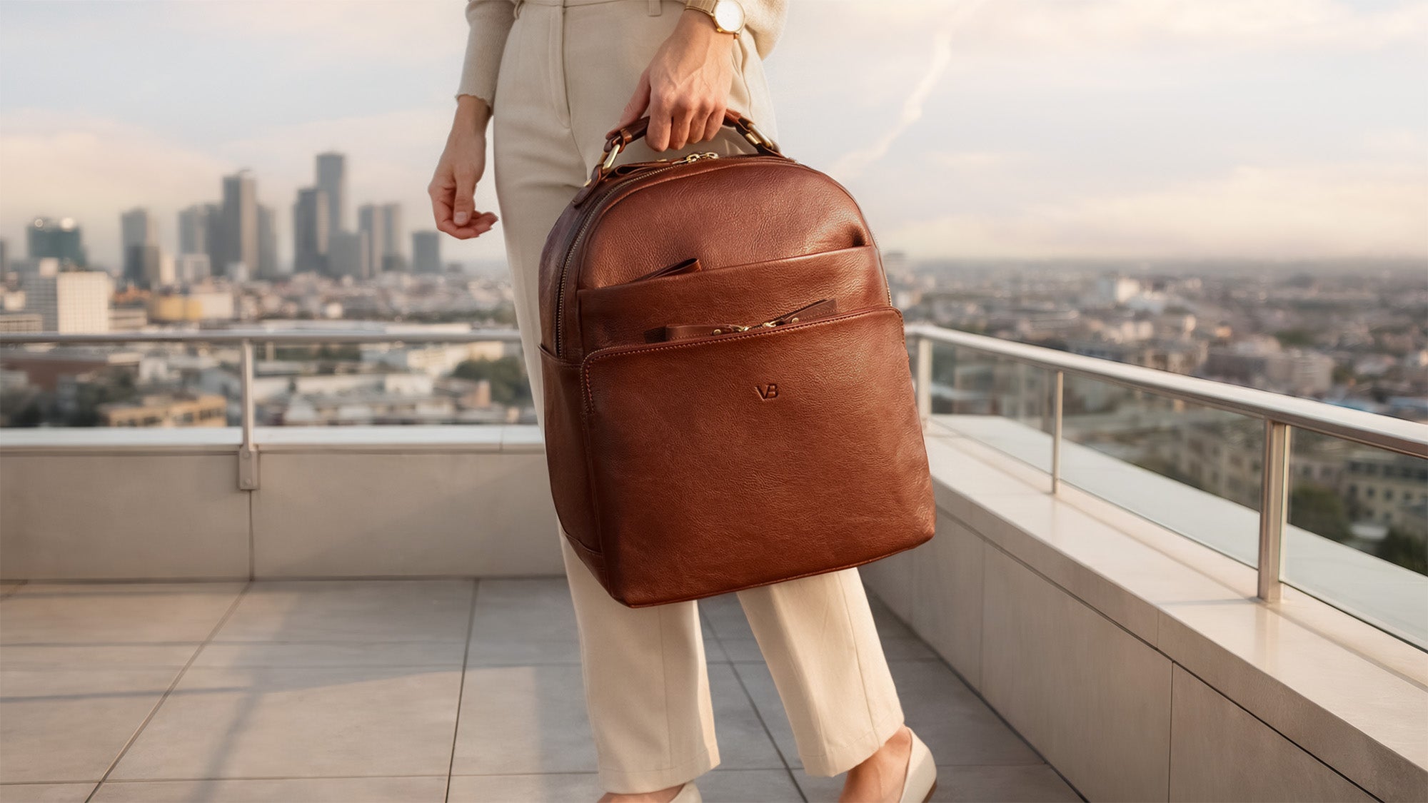 Von Baer Liberty luxury women’s brown full-grain Italian leather backpack with model on a New York rooftop.